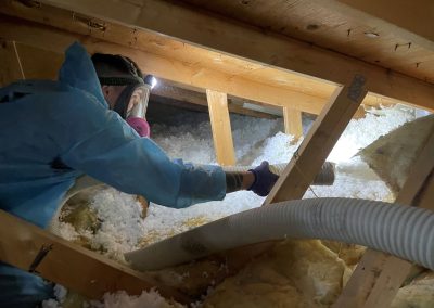 attic insulation contractor working with blow in insulation