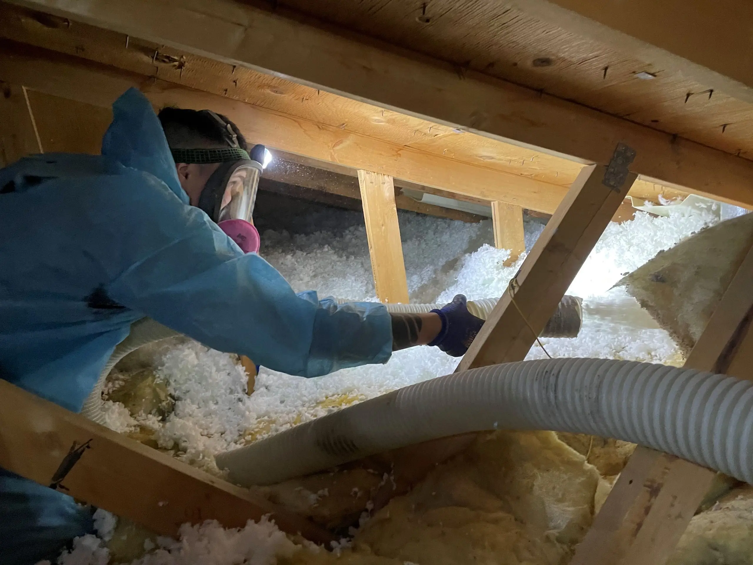 attic insulation contractor working with blow in insulation
