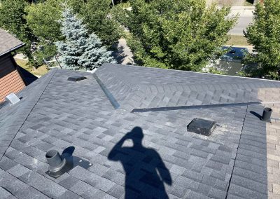 roof with shingles and the shadow of a person